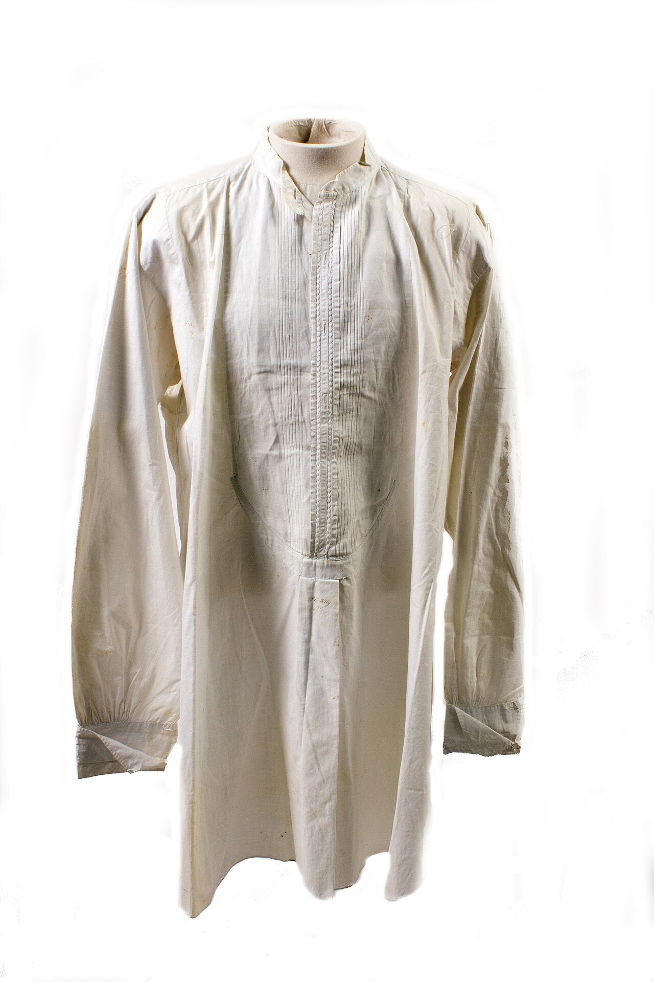 Cream long-sleeved band-collar shirt with a pintucked front panel, displayed on a mannequin