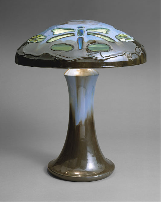 Glazed ceramic table lamp with a flared pedestal base and domed shade, photographed on a plain grey background