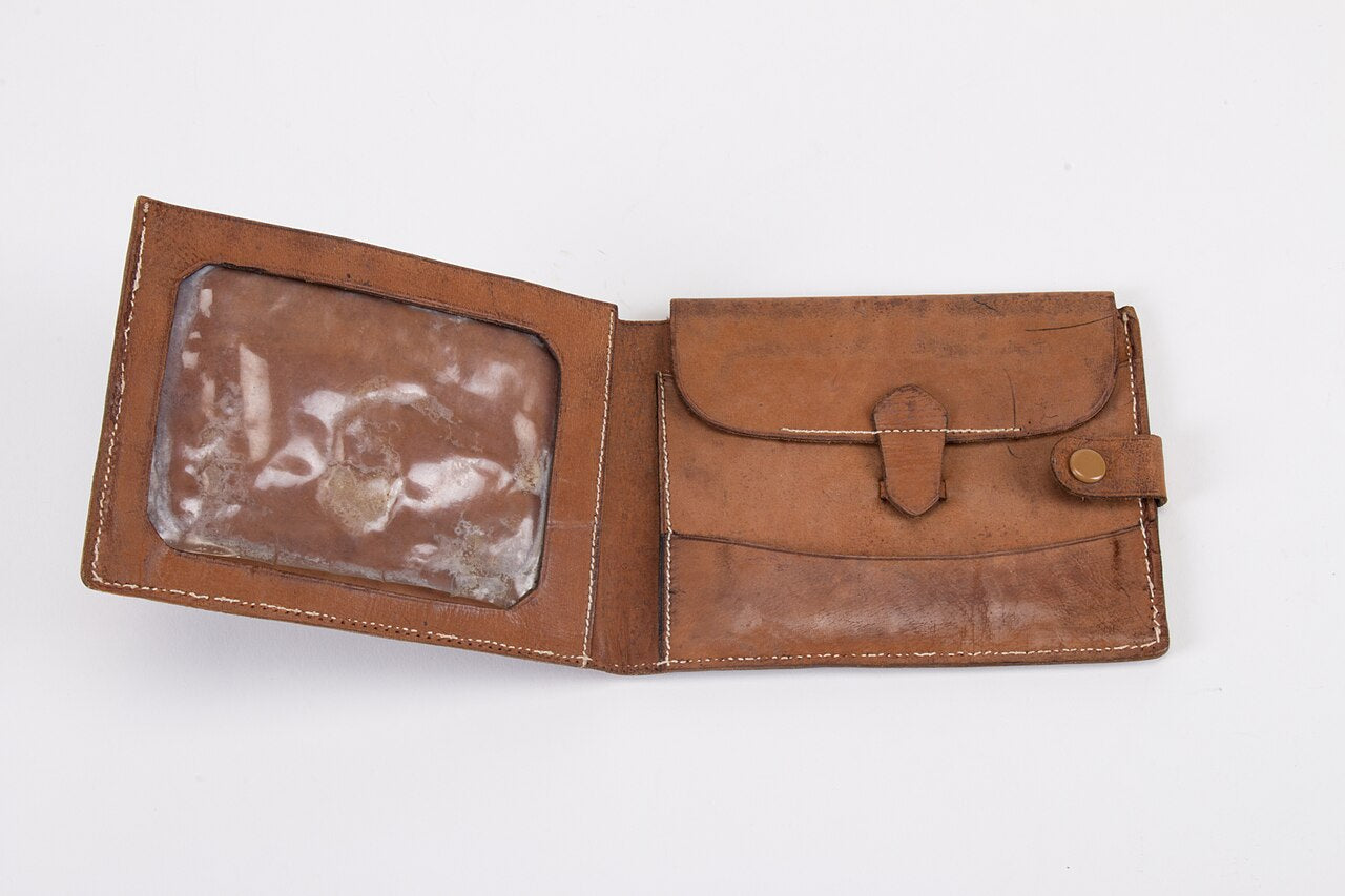 Open brown leather bifold wallet with card window and snap coin pocket on a white background