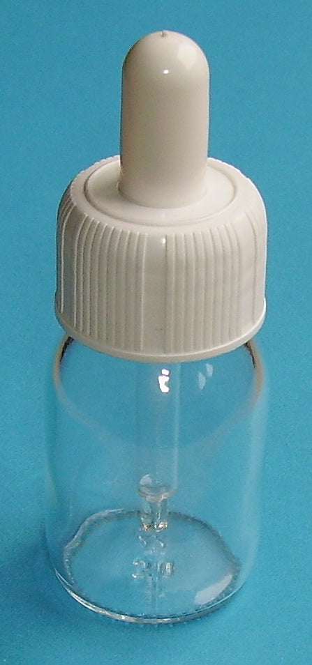Small clear glass bottle fitted with a ribbed white dropper cap on a plain blue background